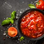 Tomato,Sauce,In,A,Bowl,With,Spices,And,Fresh,Tomatoes.